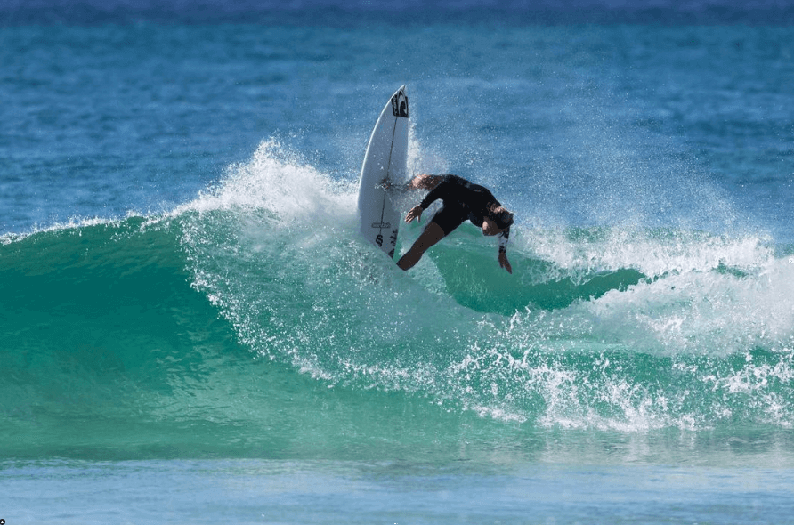 Surfer is aqua blue ocean on Central Coast