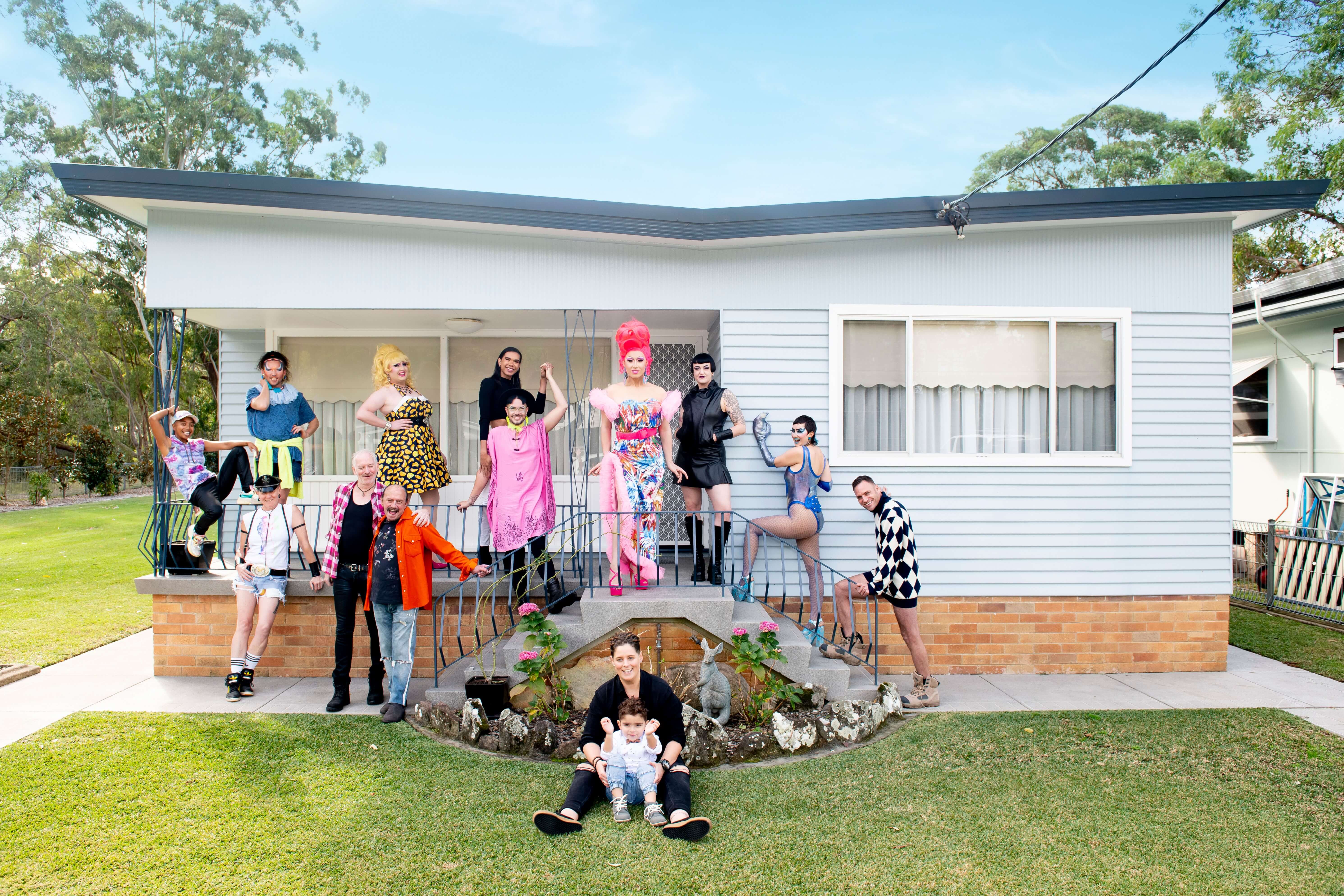 family portrait at coastal house with performers out front