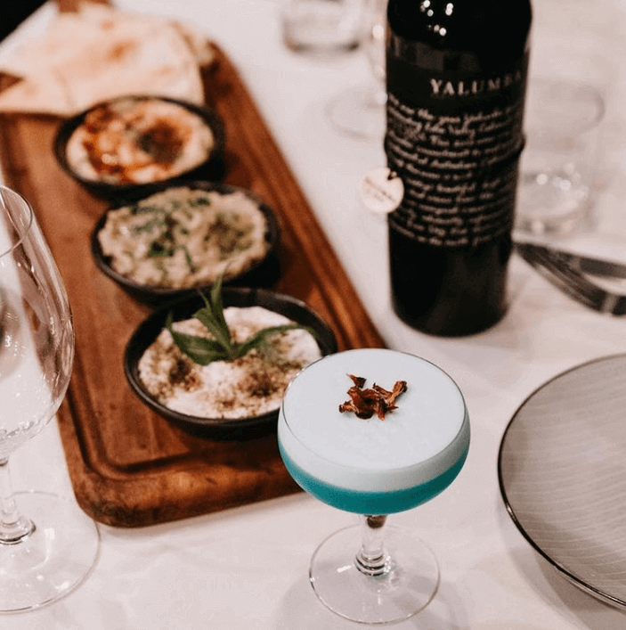 mezze board feast with fancy cocktail