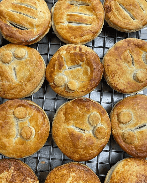 tray of pies on warmer rack