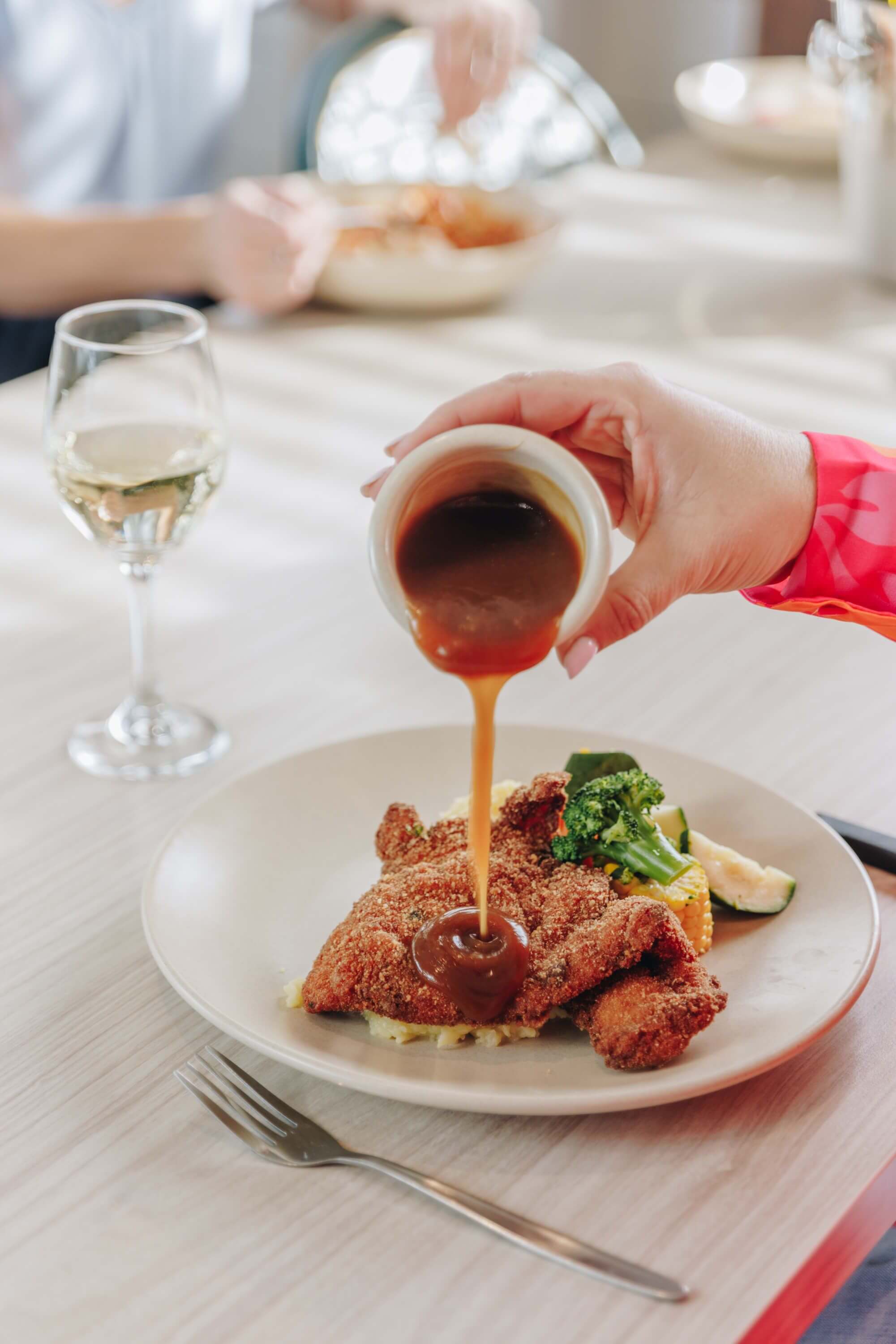 gravy poured on schnitty chicken meal