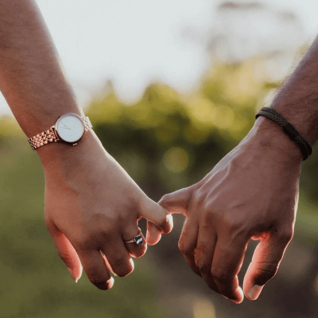 Engaged couple holding hands