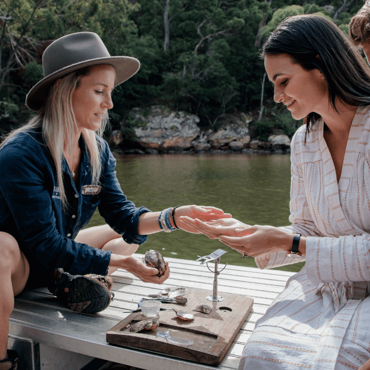 women holding pearls on pearling boat