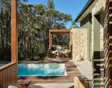 The Lodges from Bells at Killcare outside entertainment area overlooking a private pool.