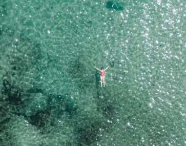 woman floating on turquoise water