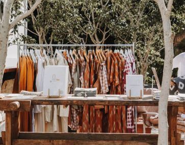 local seaside market stall with clothing and journals