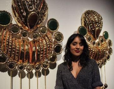 Gosford Art Gallery's EMERGING 2023 art prize winner Monica Rani Rudhar standing in front of her super sized earrings installation 