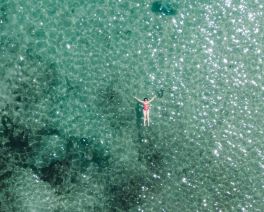 woman floating on turquoise water