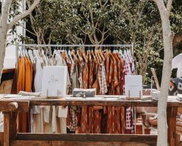 local seaside market stall with clothing and journals