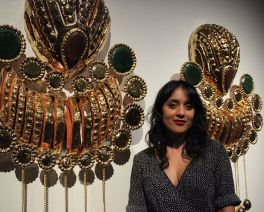 Gosford Art Gallery's EMERGING 2023 art prize winner Monica Rani Rudhar standing in front of her super sized earrings installation 