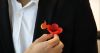 Gosford RSL Club ANZAC Day Image. Staff member putting poppy in pocket.