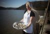 woman holding oysters at mooney mooney oyster farm tour