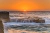 ocean on rocks at sunset