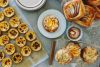 table covered with fresh baked pastries