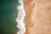 aerial of beach with sand and waves perfectly segmented